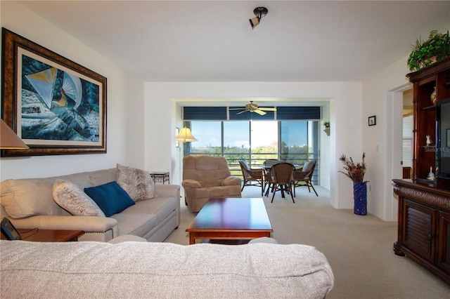 carpeted living room featuring ceiling fan