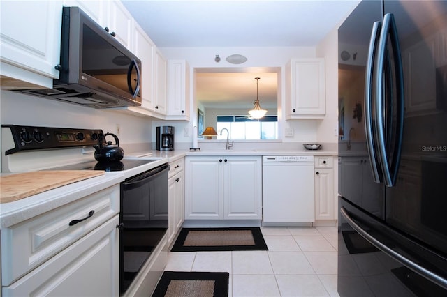 kitchen featuring electric stove, black refrigerator, white cabinetry, white dishwasher, and light tile patterned flooring