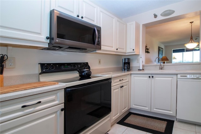 kitchen with white cabinetry, dishwasher, electric stove, and light tile patterned floors