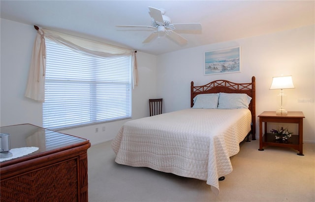 bedroom featuring ceiling fan and carpet