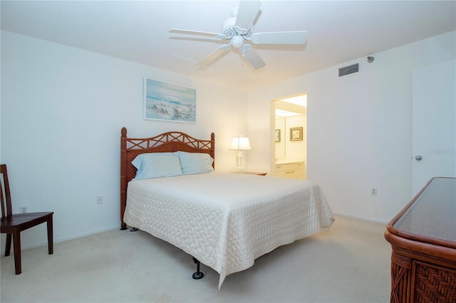 carpeted bedroom featuring ensuite bath and ceiling fan