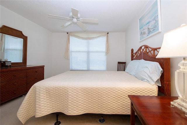 bedroom featuring ceiling fan and carpet