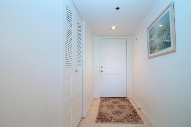 doorway with light tile patterned floors