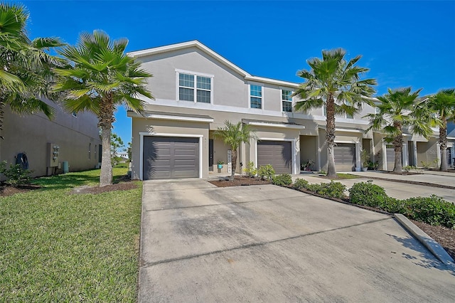 view of front of house with a front yard and a garage