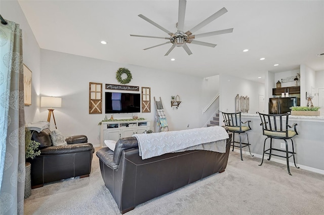 carpeted living room featuring ceiling fan