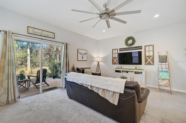 carpeted living room with ceiling fan