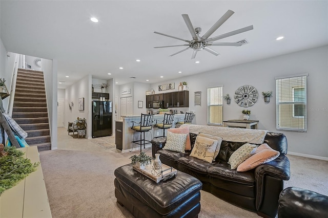 living room with light carpet and ceiling fan