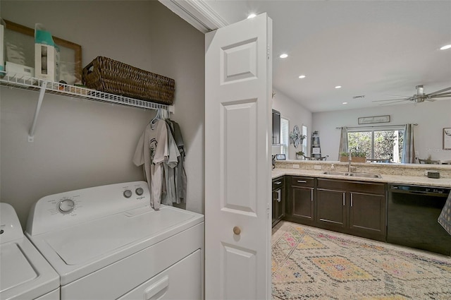 washroom featuring ceiling fan, sink, and separate washer and dryer