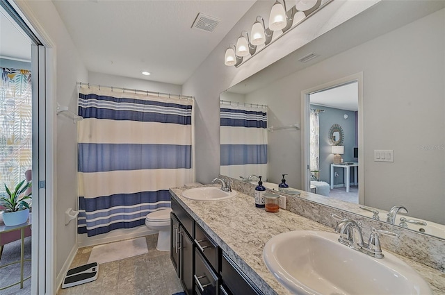 bathroom with dual bowl vanity, toilet, and tile floors