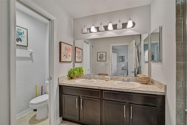 bathroom with tile flooring, vanity with extensive cabinet space, toilet, and dual sinks