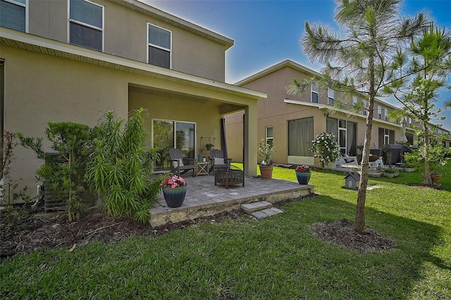 rear view of property featuring a patio area and a yard