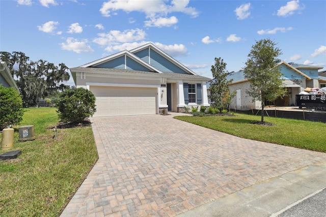 view of front of property featuring a front yard and a garage