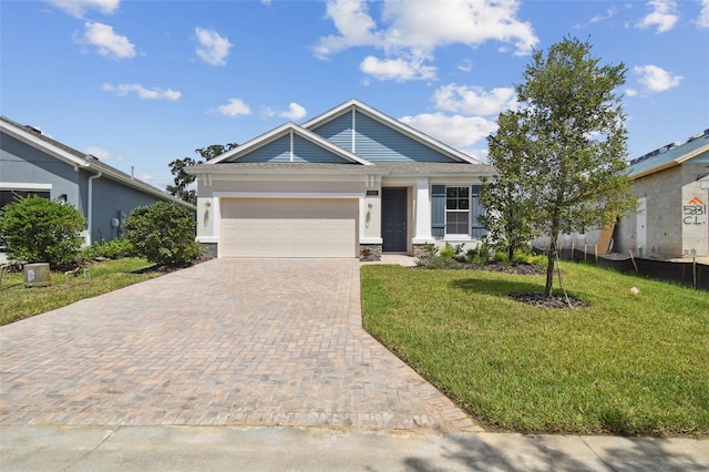 view of front of home with a front lawn and a garage