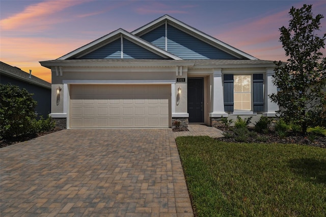 view of front of home featuring a lawn and a garage