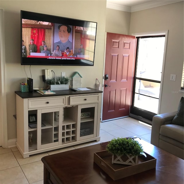 living room featuring ornamental molding and tile floors