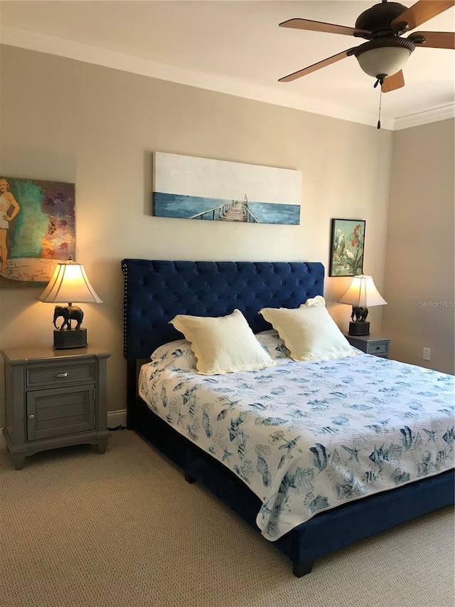 carpeted bedroom with ceiling fan and crown molding