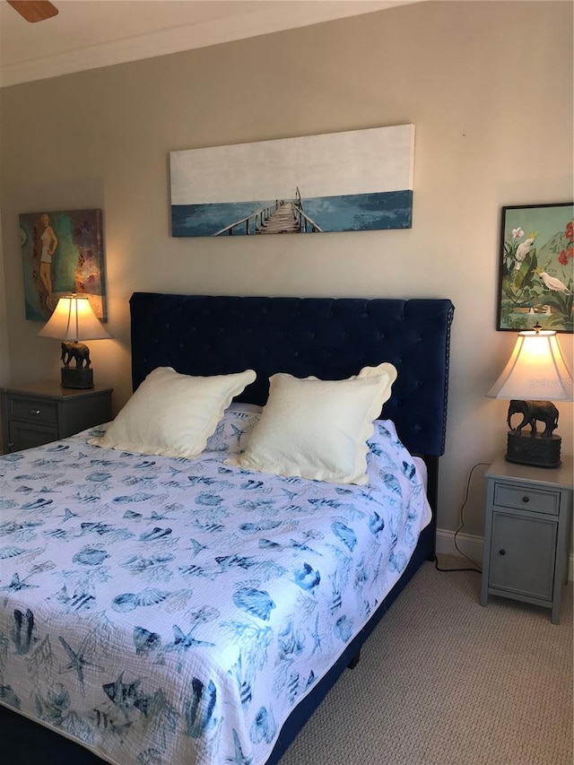 bedroom with light carpet and crown molding