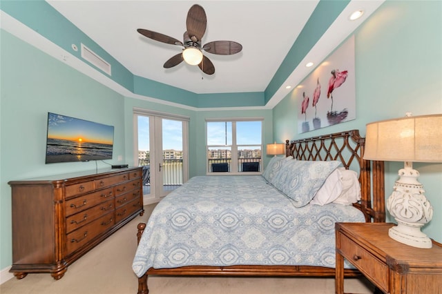 bedroom with access to outside, ceiling fan, and light colored carpet