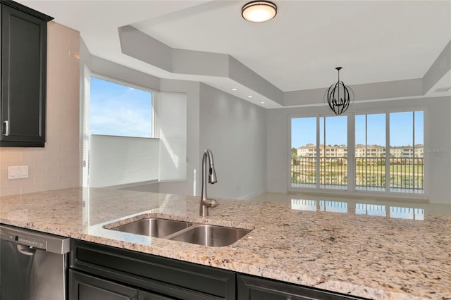 kitchen with pendant lighting, stainless steel dishwasher, a healthy amount of sunlight, and sink