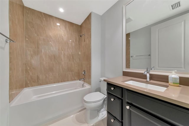 full bathroom featuring vanity, tiled shower / bath combo, and toilet