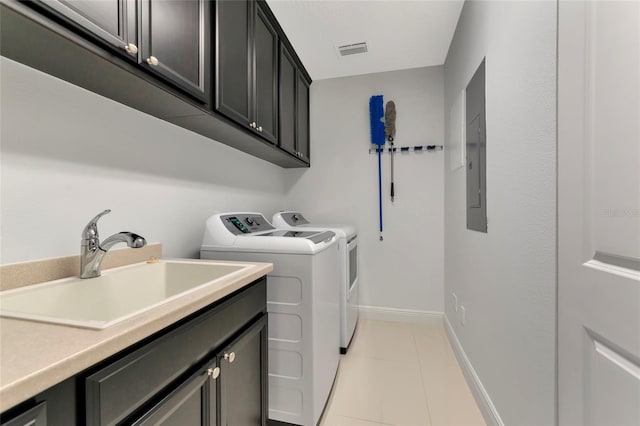 laundry room with sink, cabinets, independent washer and dryer, electric panel, and light tile patterned floors