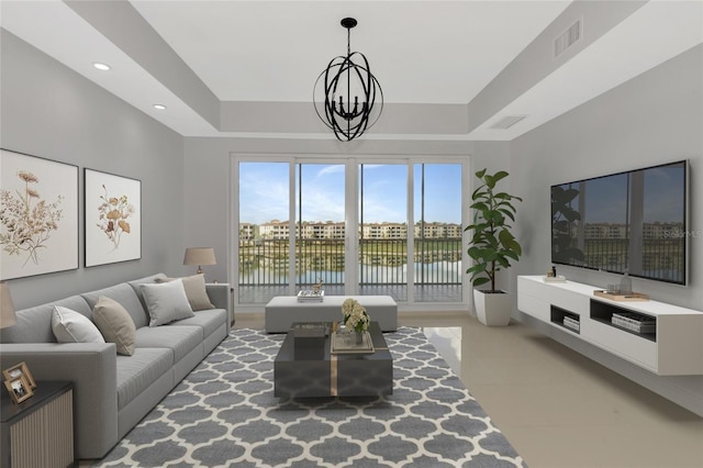 living area featuring visible vents, a tray ceiling, a notable chandelier, and recessed lighting