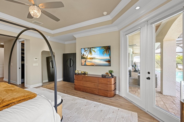 bedroom featuring ceiling fan, crown molding, light wood-type flooring, french doors, and access to outside