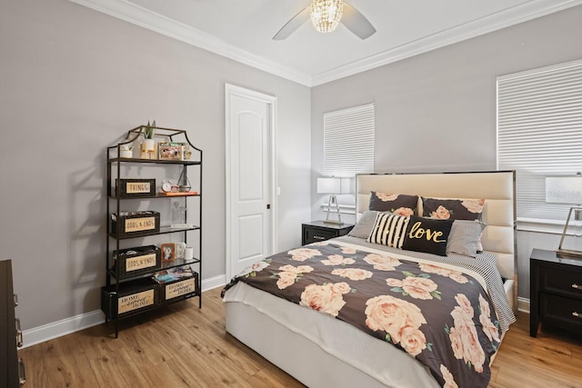 bedroom featuring crown molding, ceiling fan, and light hardwood / wood-style flooring