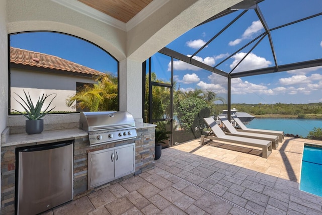 view of patio / terrace featuring an outdoor kitchen, a lanai, a grill, and a water view