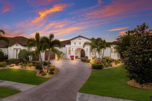 mediterranean / spanish house featuring a yard