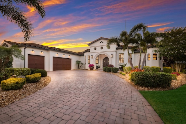 mediterranean / spanish home featuring a garage