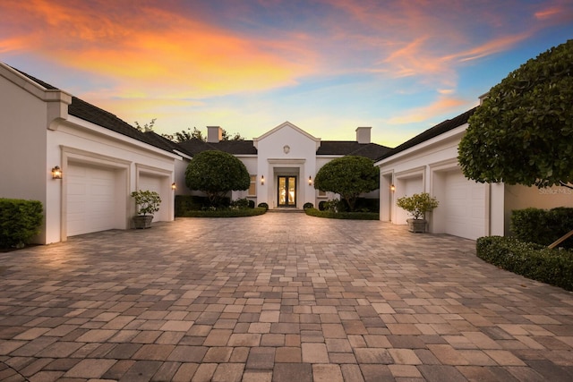 view of front of home with french doors and a garage