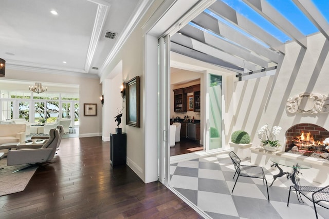 interior space with a chandelier, crown molding, and dark wood-type flooring