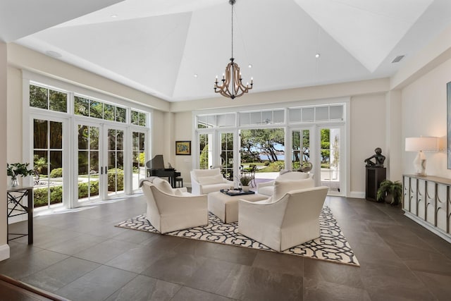 living room with french doors, high vaulted ceiling, and a notable chandelier