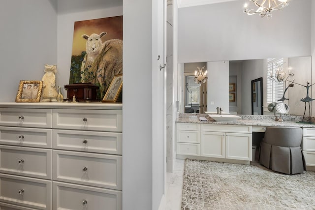 bathroom with vanity and a chandelier