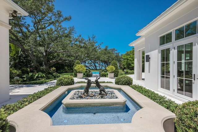 view of swimming pool with french doors