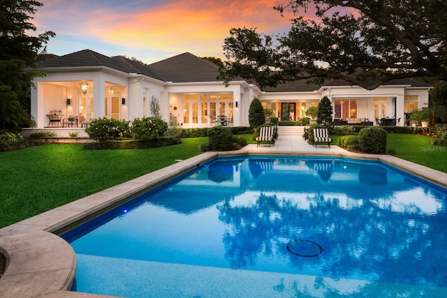 pool at dusk with a yard