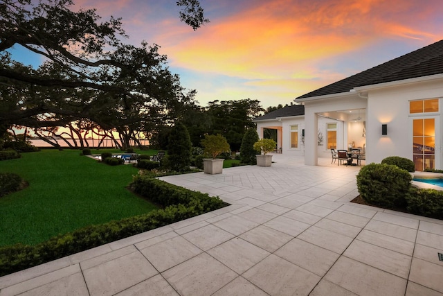 patio terrace at dusk with a yard