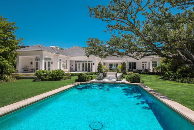 view of pool featuring a lawn