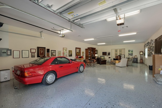 garage featuring electric panel and a garage door opener