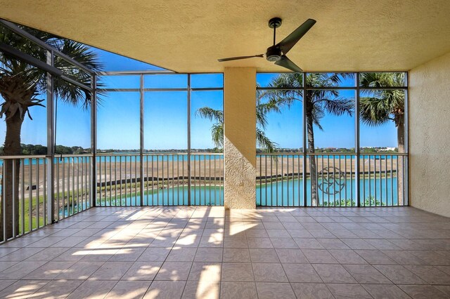 exterior space featuring a water view and ceiling fan