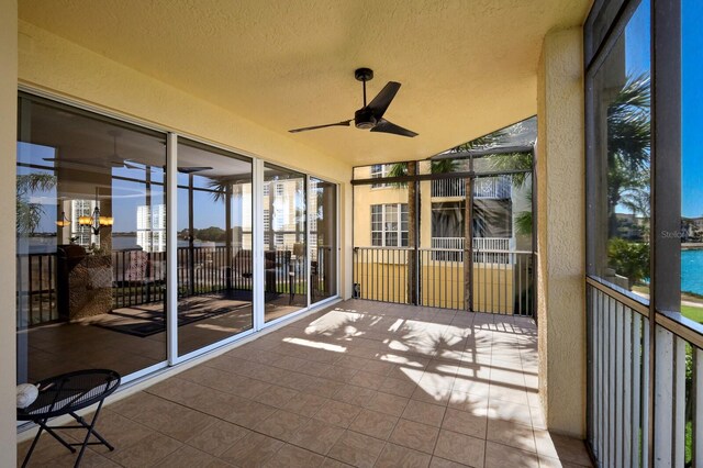 unfurnished sunroom featuring a wealth of natural light and ceiling fan