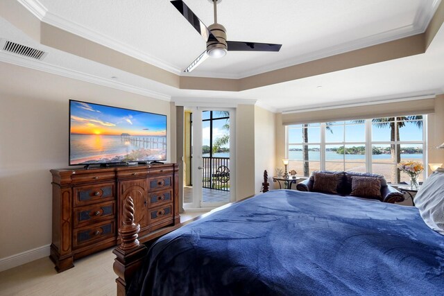 bedroom with ceiling fan, a water view, access to exterior, and multiple windows