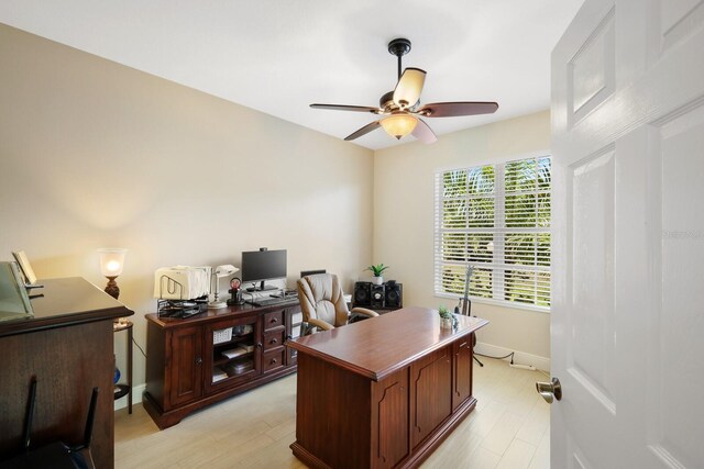 office area with light hardwood / wood-style floors and ceiling fan