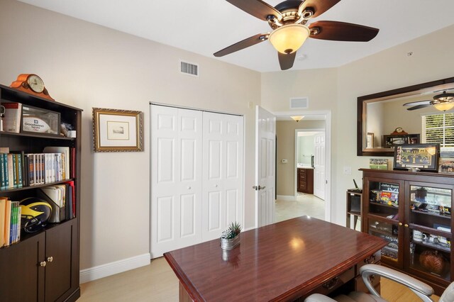 office featuring ceiling fan and light tile floors