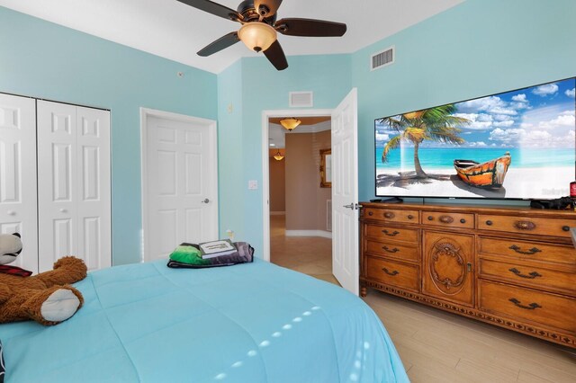 bedroom with a closet, ceiling fan, and light wood-type flooring