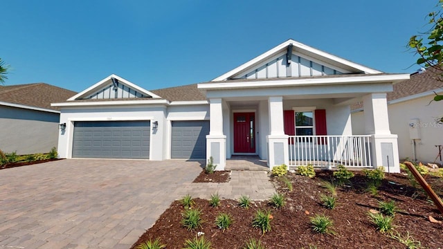 view of front facade featuring a porch and a garage