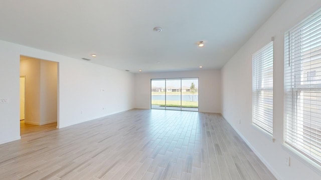 unfurnished room with light hardwood / wood-style floors