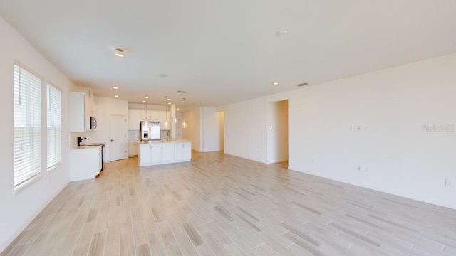 unfurnished living room featuring light hardwood / wood-style flooring