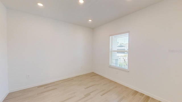 unfurnished room with light wood-type flooring